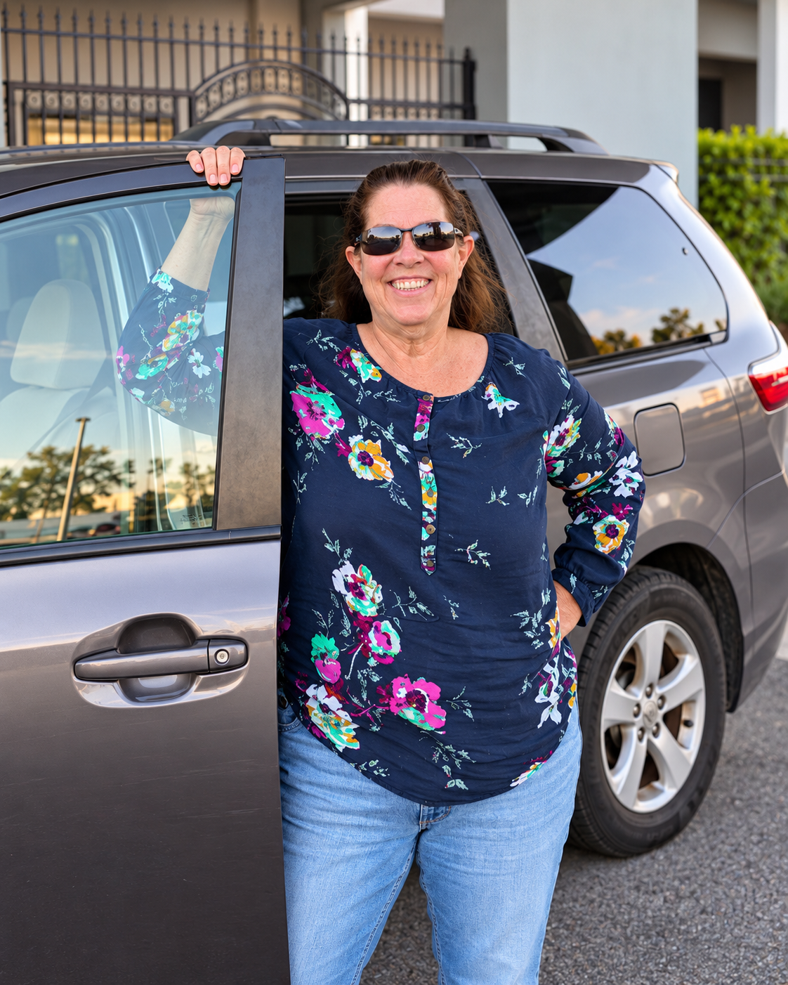 Cheryl standing beside her vehicle, smiling and ready to welcome Gulf Coast travelers